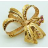 A 18ct gold pendant/ brooch in a bow set with rubies, 6.5g