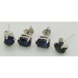 Two pairs of 14ct white gold earrings set with oval cut sapphires