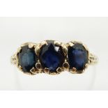 A 9ct gold ring set with three sapphires, 2.0g, size O