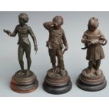 Three spelter figures of children/scholars with books, tallest 30cm