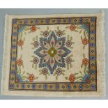 Turkish miniature silk rug with floral decoration on a cream ground, 27 x 22 cm.