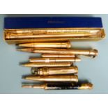 Nine gold plated and yellow metal propelling pencils, one an Eversharp example in original box.