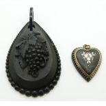Victorian carved jet pendant depicting a grape vine and an inlaid heart pendant