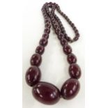 A graduated cherry amber necklace made up of 63 oval beads, 73g