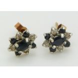 A pair of 9ct gold earrings set with sapphires and diamonds