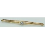 A 9ct gold bar brooch set with an old cut diamond measuring approximately 0.2ct