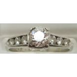 A platinum ring set with a diamond measuring approximately 0.65ct and six further diamonds to the