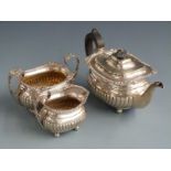 Edward VII hallmarked silver three piece teaset with fluted lower bodies, London 1908 maker Edward