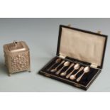 Seven hallmarked silver teaspoons in case, 48g together with an embossed plated tea caddy.
