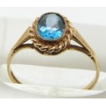 A 9ct gold ring set with an oval cut topaz, 1.4g, size L