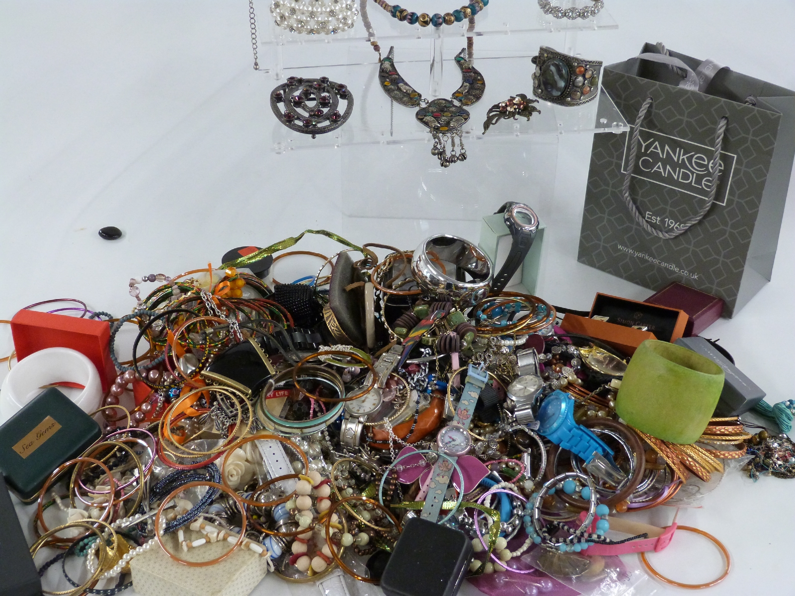 A collection of costume jewellery including beads, bangles, watches etc