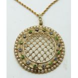 Edwardian circular pendant set with seed pearls in a lattice design within a border set with