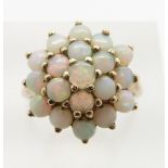 A 9ct gold ring set with a cluster of opals, 4.3g, size M