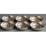 Six white metal bowls or pin dishes with applied medallions to bases, marked to underside of one