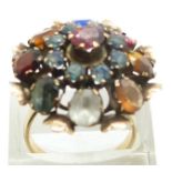 A 14k gold ring set with a pink sapphire, blue/ green sapphires, tiger's eye, ruby, garnet,