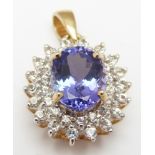 A 9ct gold pendant set with an oval cut tanzanite surrounded by diamonds