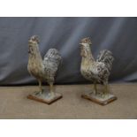 A pair of Chinese pottery cockerels on wooden plinths, height 51cm