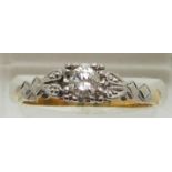 An 18ct gold ring set with a diamond of approximately 0.25ct in a platinum setting, 3.0g, size O