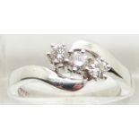 COLLECTING An 18ct white gold ring set with three diamonds in a twist setting, 5.4g , size N