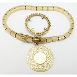 An 18ct gold bracelet made up of segmented rectangular links, an 18ct gold fob/ charm and an 18ct