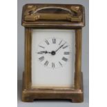 Carriage clock in brass corniche style case, enamel Roman dial with blued steel hands, 11cm tall