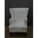 White upholstered chair raised on ball and claw feet