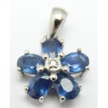 A 14k white gold pendant set with a diamond and sapphires