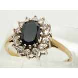 A 9ct gold ring set with a sapphire surrounded by cubic zirconia, 2.1g, size S