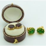 A pair of 18ct gold earrings set with garnets and another pair set with a cluster of green stones