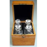 Asprey London oak bottle case set with four 19C or early 20thC cut glass decanters or apothecary