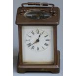 Carriage clock in brass case, the enamel Roman dial with steel hands, the keyless movement visible