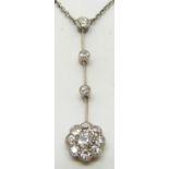 An 18ct white gold pendant / necklace set with three drop diamonds leading to a diamond cluster, 5g