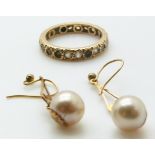 A 9ct gold eternity ring (2.6g) and a pair of 9ct gold earrings set with a faux pearl to each
