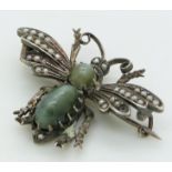 A silver insect brooch set with seed pearls and two cat's eye cabochons, 3 x 4.2cm
