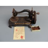 Vintage Wellington sewing machine with certificate of quality and canvas pin purse.