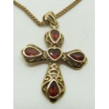 A 9ct gold cross pendant set with garnets, 3 x 2cm, 4.3g