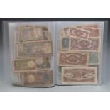 Over sixty world banknotes in a collector's folder to include Germany, China, Chile, Austria,