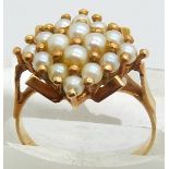 An 18ct gold ring set with pearls,4.2g, size N