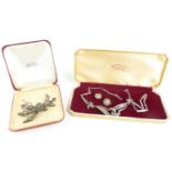 A silver necklace set with marcasite, earrings and brooch