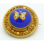 Victorian brooch set with an enamel butterfly on a blue guilloché enamel ground, verso a glass
