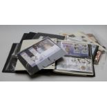 Three stamp and coin albums with first day covers containing collectable coin covers including £