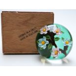 William Manson 'weight in a crate' paperweight with lampwork flowers on green ground and signature