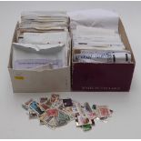 Two boxes of loose stamps in envelopes