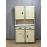 A retro metal kitchen cabinet/dresser with four vented doors and two drawers, one with cutlery