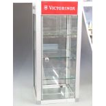A glazed and brushed steel haberdashery/shopfitting display cabinet with Maglite and Victorinox