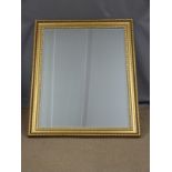 A large bevelled glass mirror W106 x 91cm