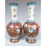 A pair of 19thC/ ealy 20thC cloisonné vases with bird and floral decoration, 21.5cm tall