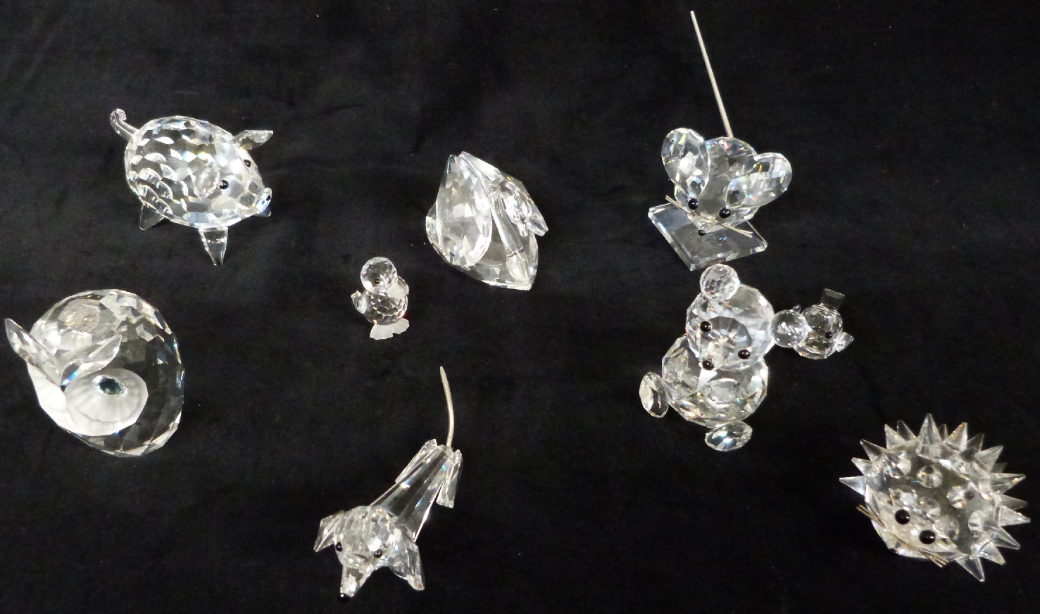 A collection of nine Swarovski animals including hedgehog, owl, mouse etc