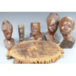 Five tribal/African wooden heads and a leather tribal cushion