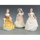 Three Royal Doulton figurines including Sandra, Gift of Love etc, tallest 22cm